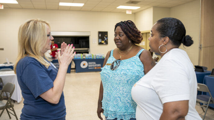 Three women speaking together at a CDE event