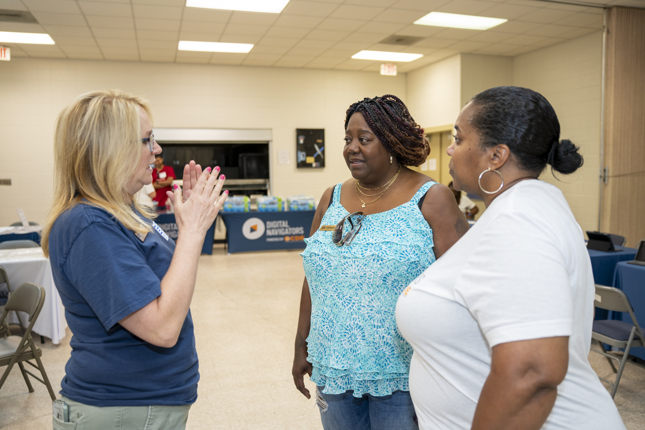 Three women speaking together at a CDE event