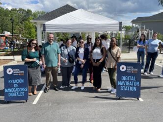 Team members standing outside Digital Navigators tent at United Way resource fair