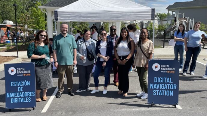 Team members standing outside Digital Navigators tent at United Way resource fair