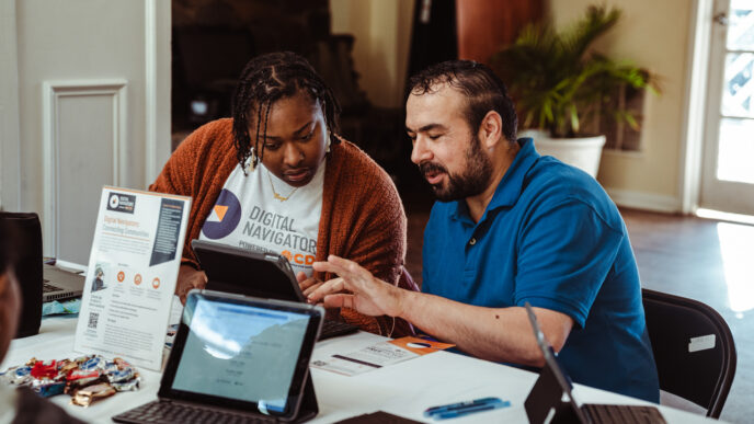 Digital Navigators working a tablet device at an event