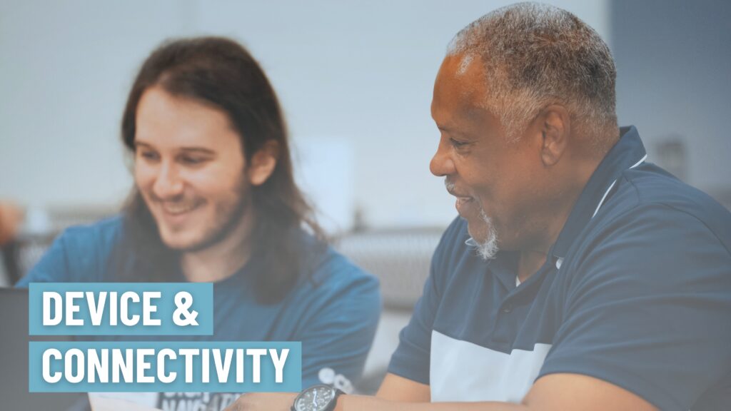 Image of a Digital Navigator supporting a community member at a laptop distribution event.
