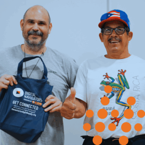 Two community members after receiving their laptops at a community event.