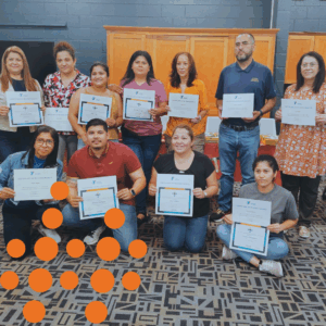 Photo of community members with certificates after completing a skilling course.